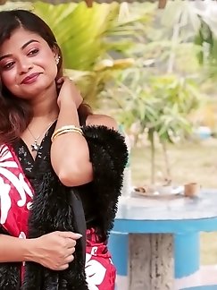 A blonde Chinese woman undressing for a photo session