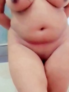 A mother seduces while indulging in a video game, as a friend watches